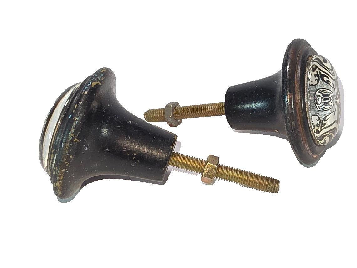 Set of 2 Black Cast Iron with White and Black Geometric Design Under Glass Knobs