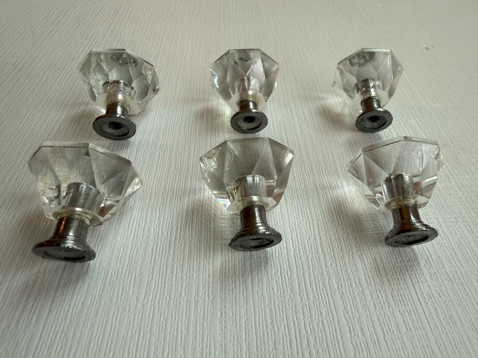 Drawer knobs that are Crystal like. Plastic. Less than 1 inch wide. Quantity 6