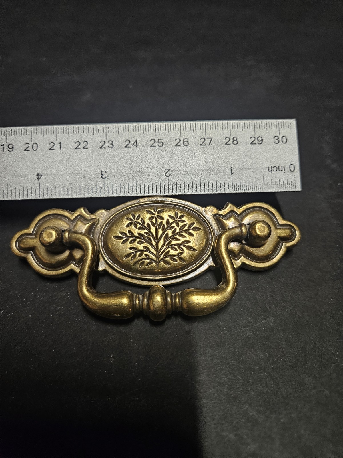 Vintage Bail Pull Features An Ornate Oval Backplate With Floral Design