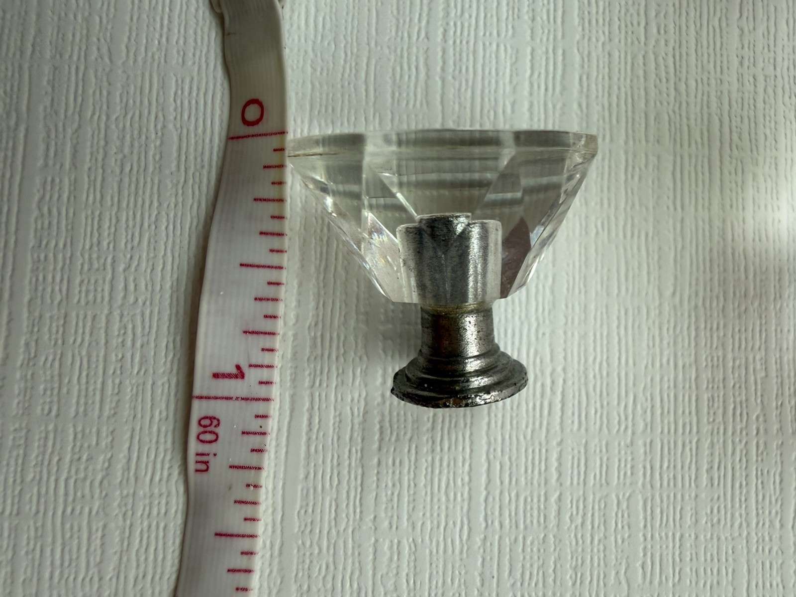 Drawer knobs that are Crystal like. Plastic. Less than 1 inch wide. Quantity 6