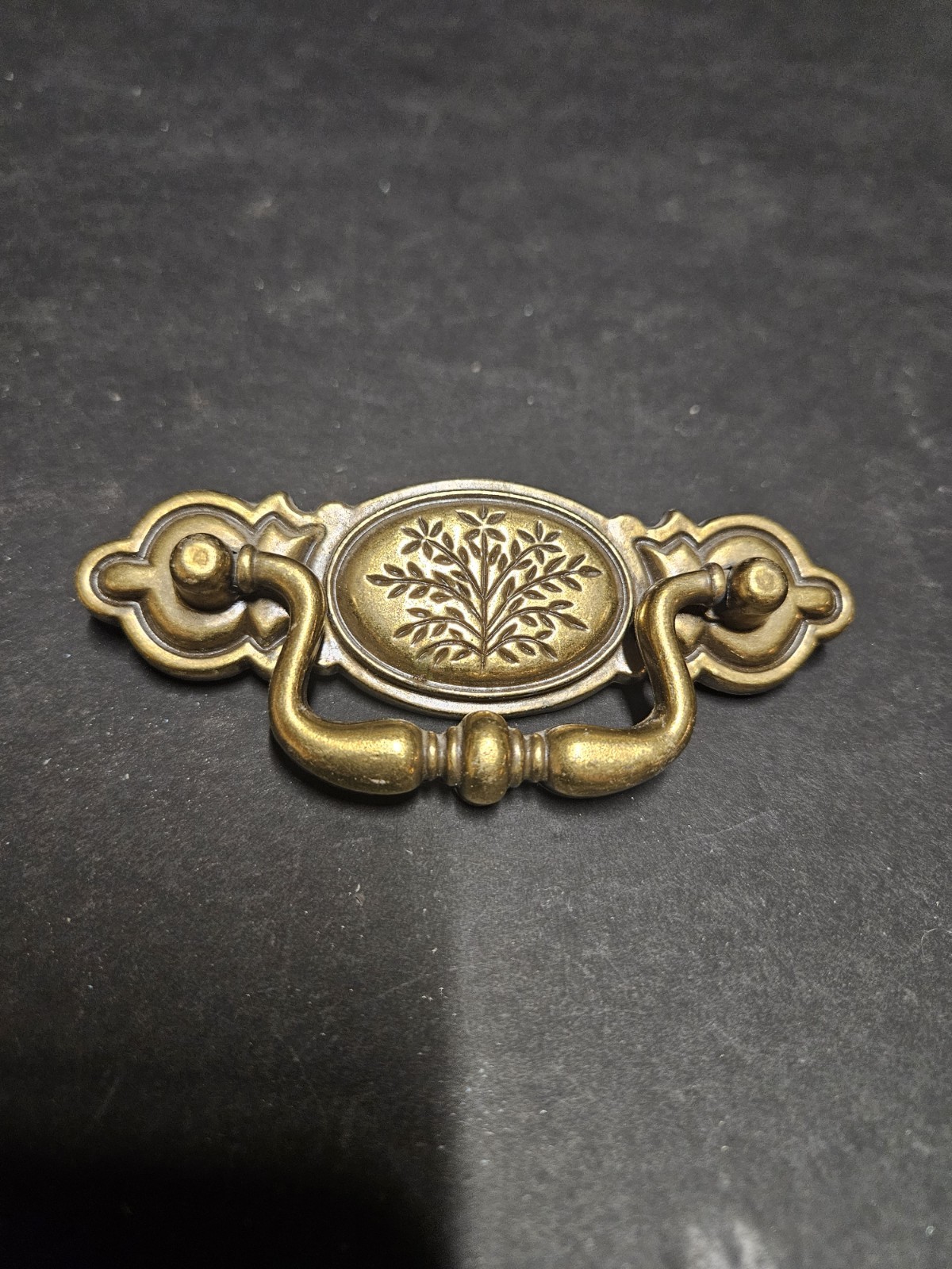 Vintage Bail Pull Features An Ornate Oval Backplate With Floral Design