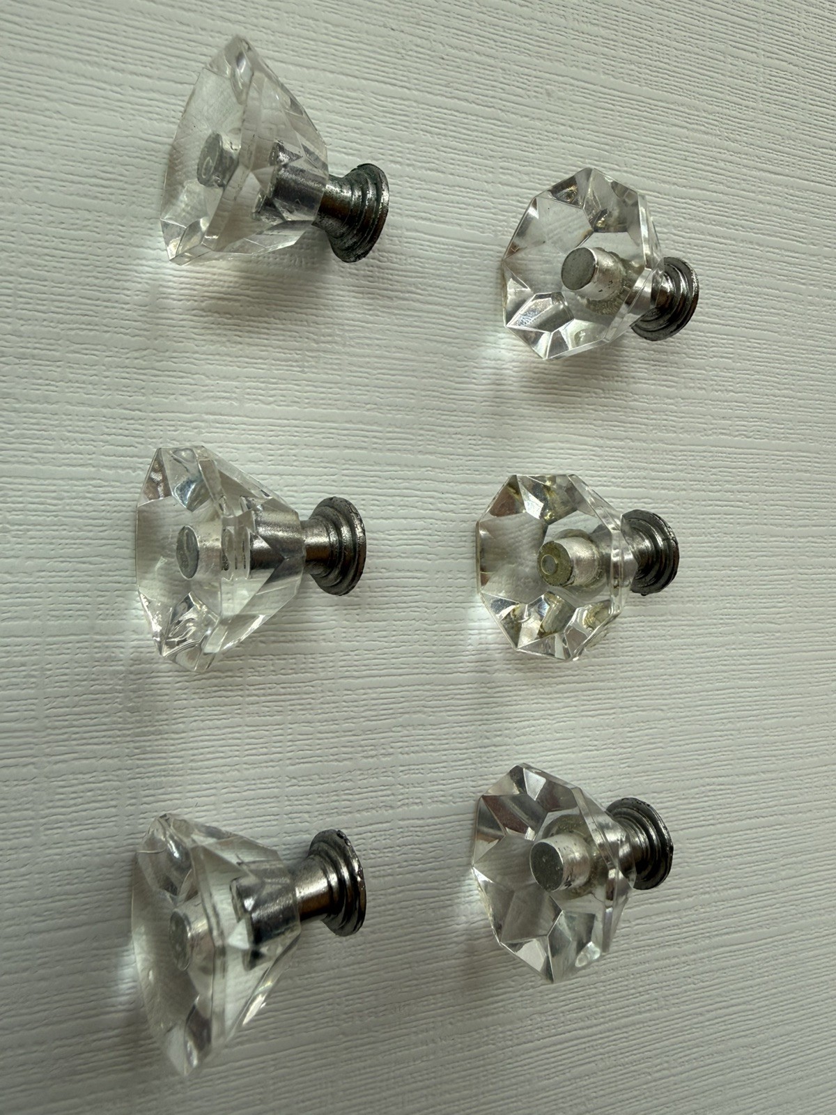Drawer knobs that are Crystal like. Plastic. Less than 1 inch wide. Quantity 6