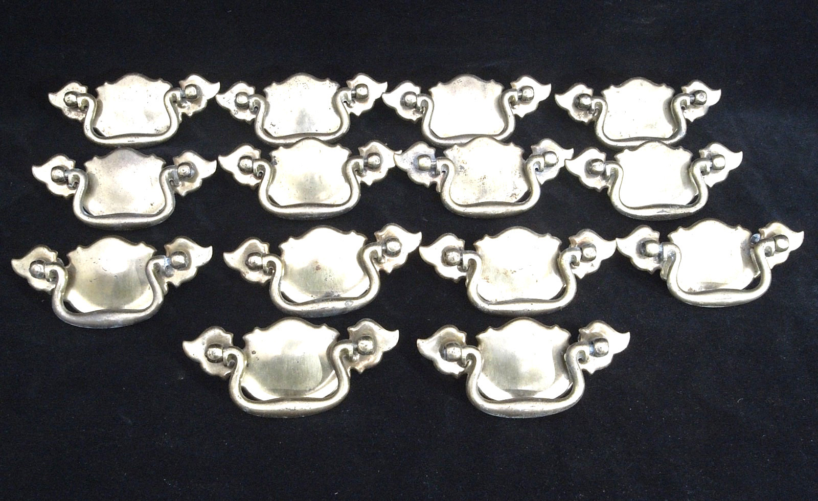 14 CHIPPENDALE BATWING BRASS TONED METAL CABINET PULLS IN VERY GOOD CONDITION