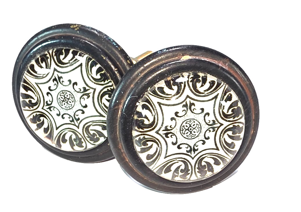 Set of 2 Black Cast Iron with White and Black Geometric Design Under Glass Knobs