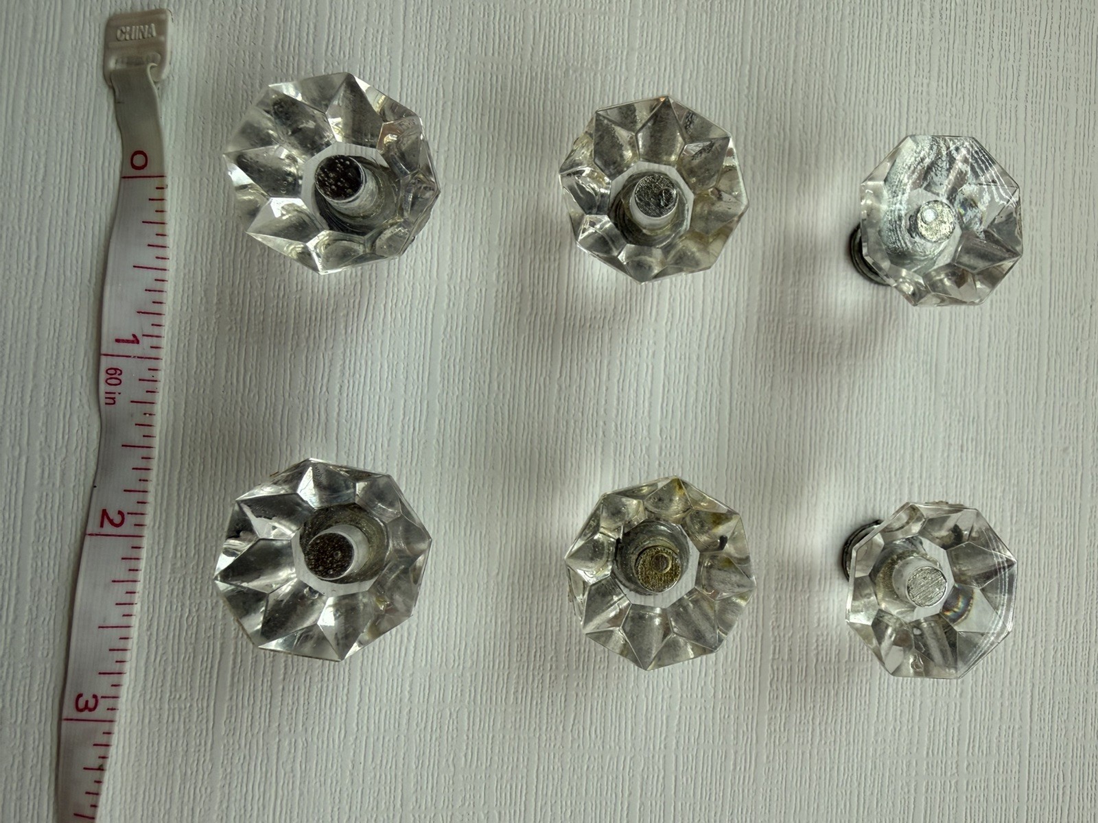 Drawer knobs that are Crystal like. Plastic. Less than 1 inch wide. Quantity 6