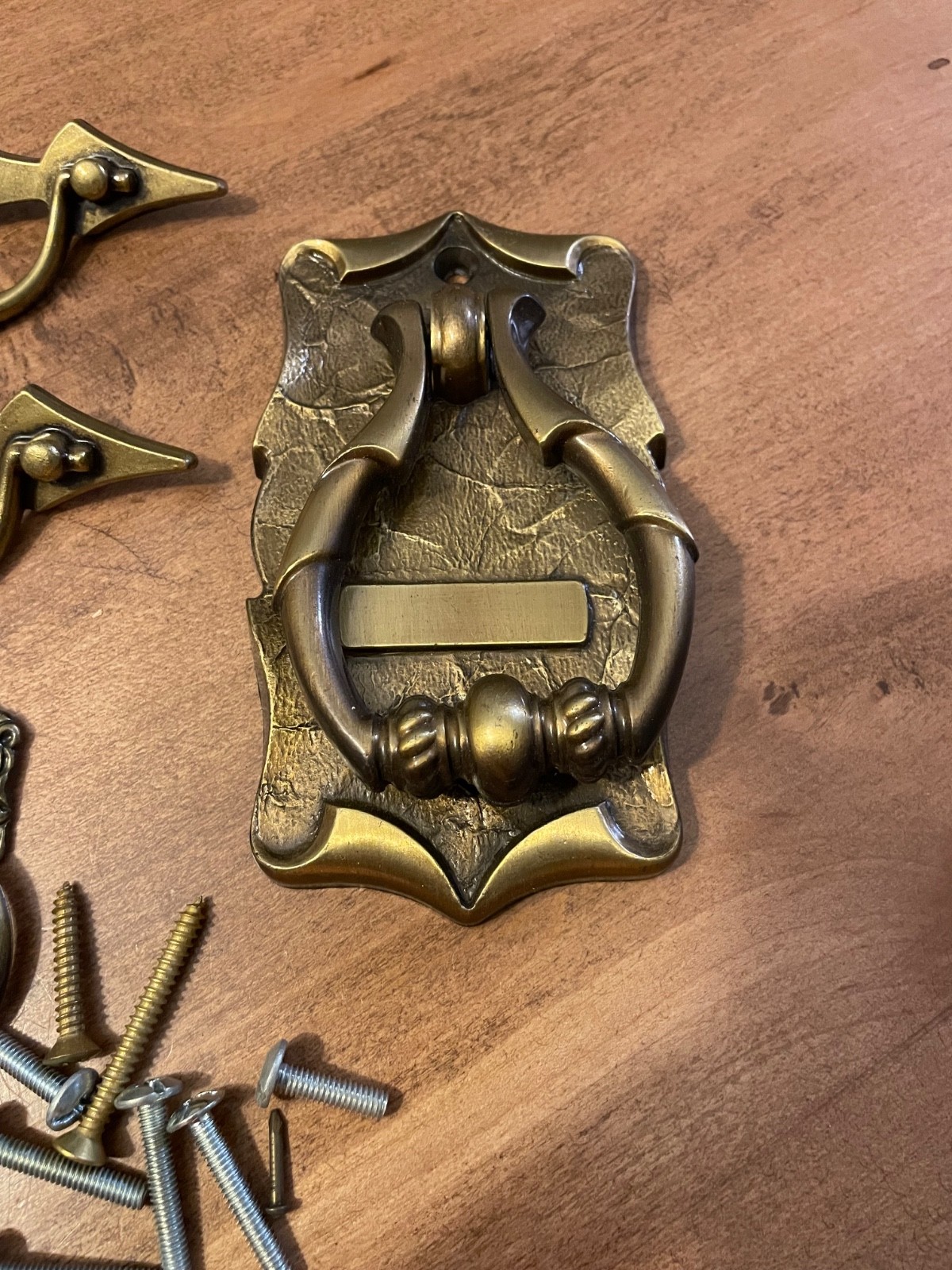 variety of vintage brass pieces, door knock, handles, and pulls never used