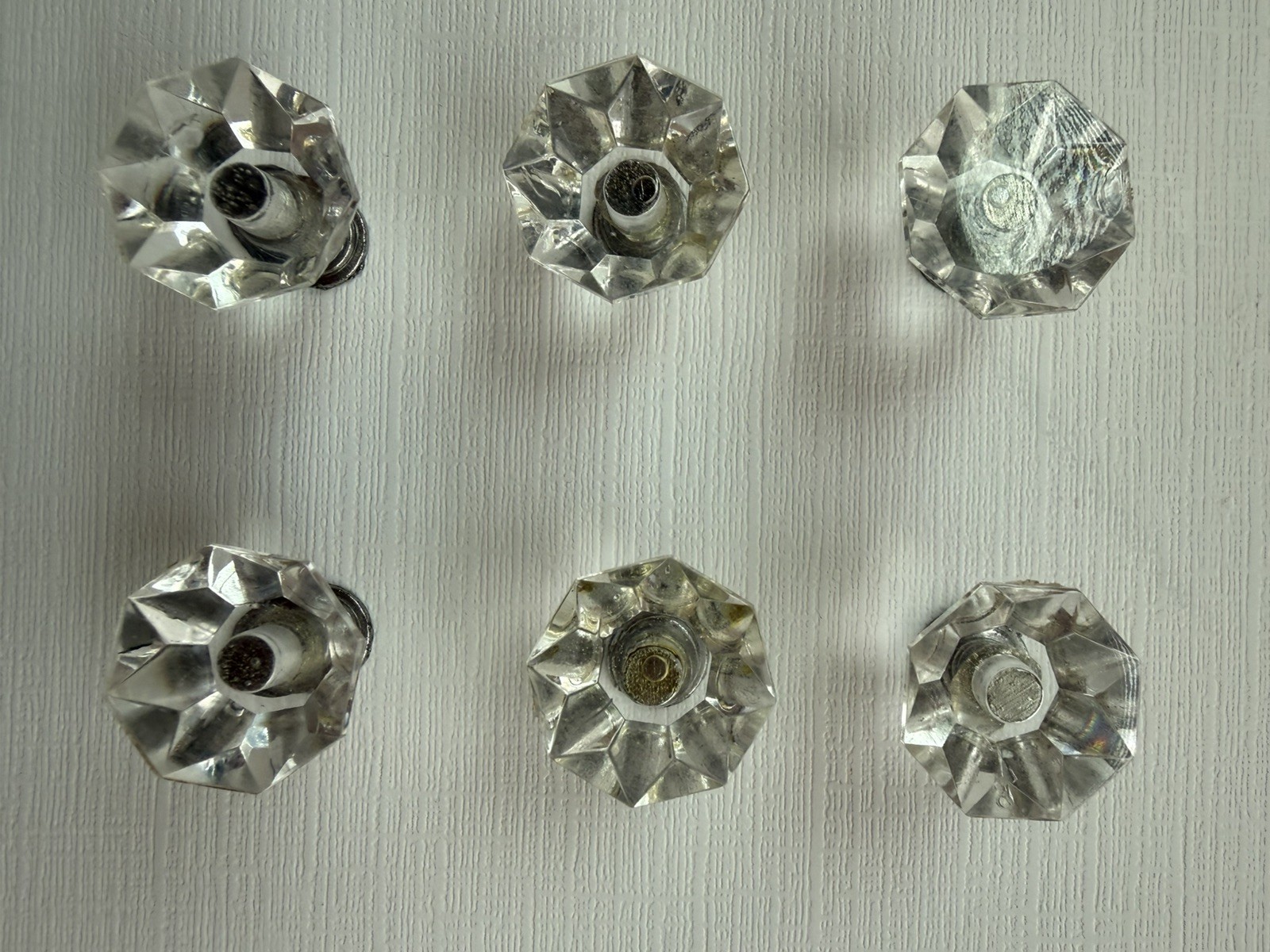 Drawer knobs that are Crystal like. Plastic. Less than 1 inch wide. Quantity 6