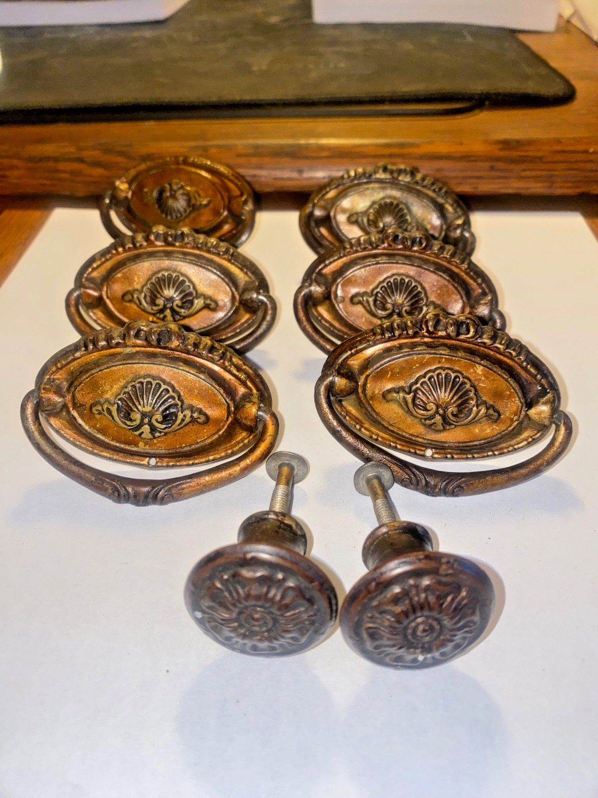 Antique set of 8 Hepplewhite pulls. 6 – 2 3/8″ drop downs and 2 – 1″ knobs .
