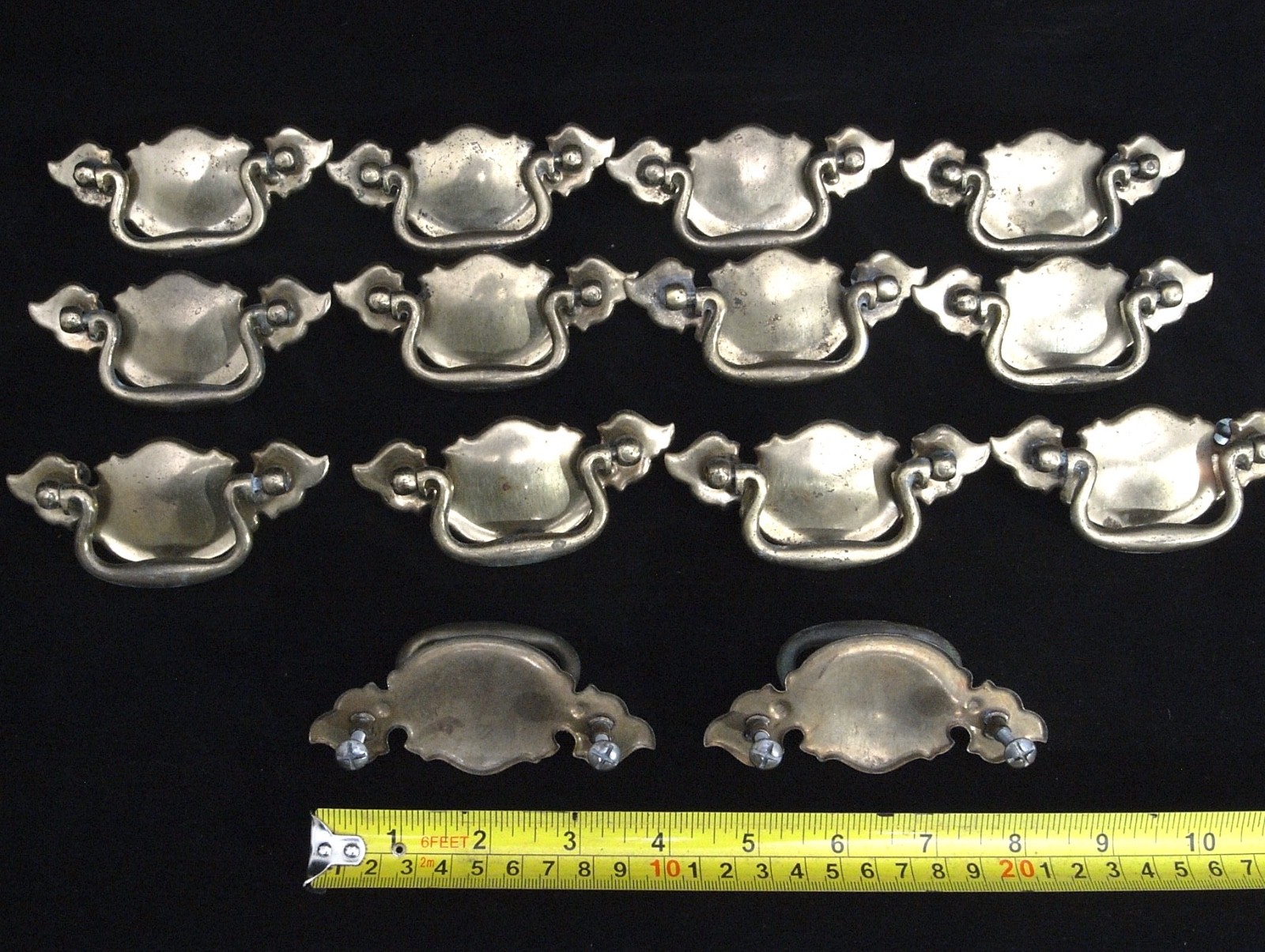14 CHIPPENDALE BATWING BRASS TONED METAL CABINET PULLS IN VERY GOOD CONDITION