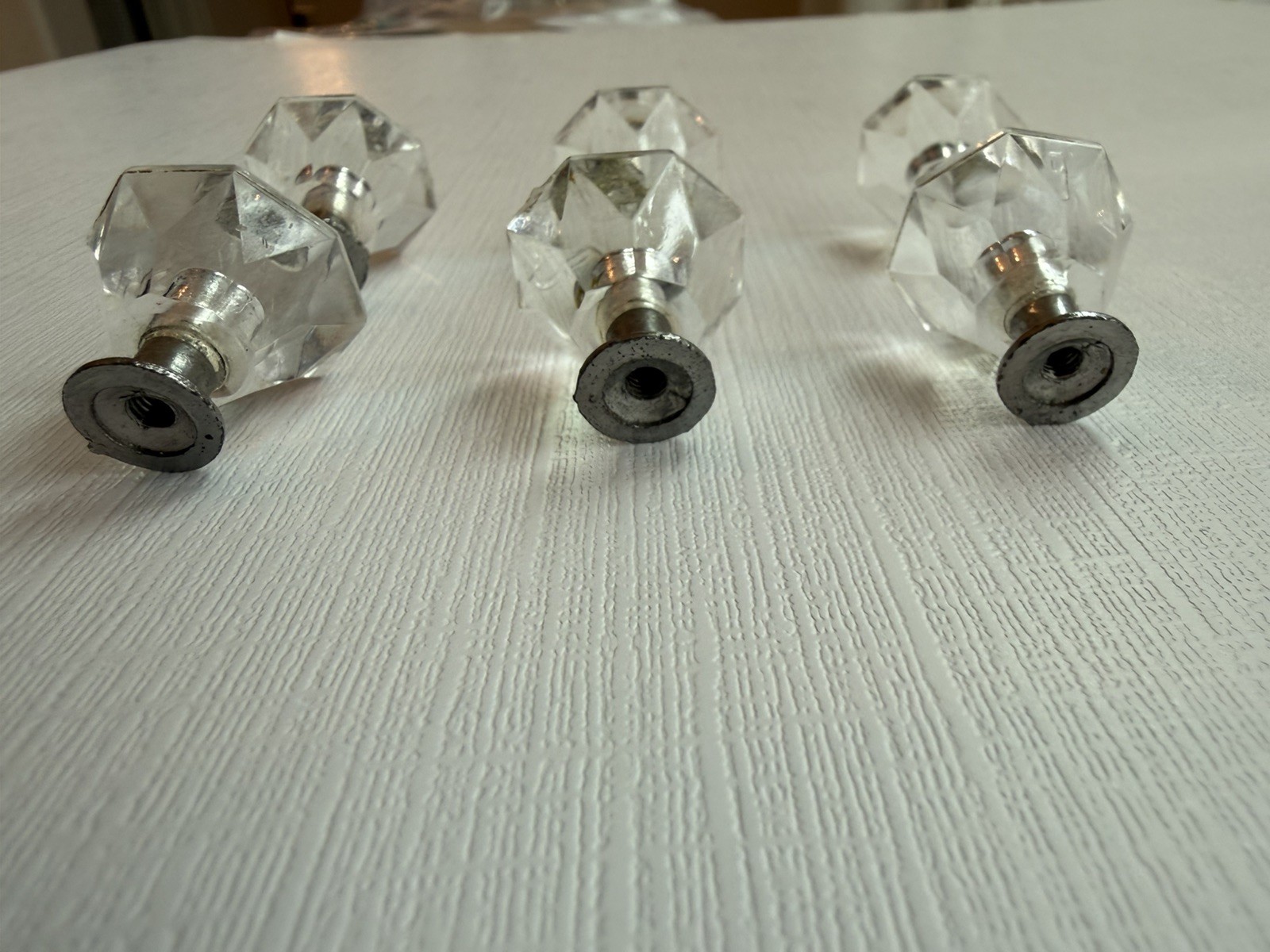 Drawer knobs that are Crystal like. Plastic. Less than 1 inch wide. Quantity 6